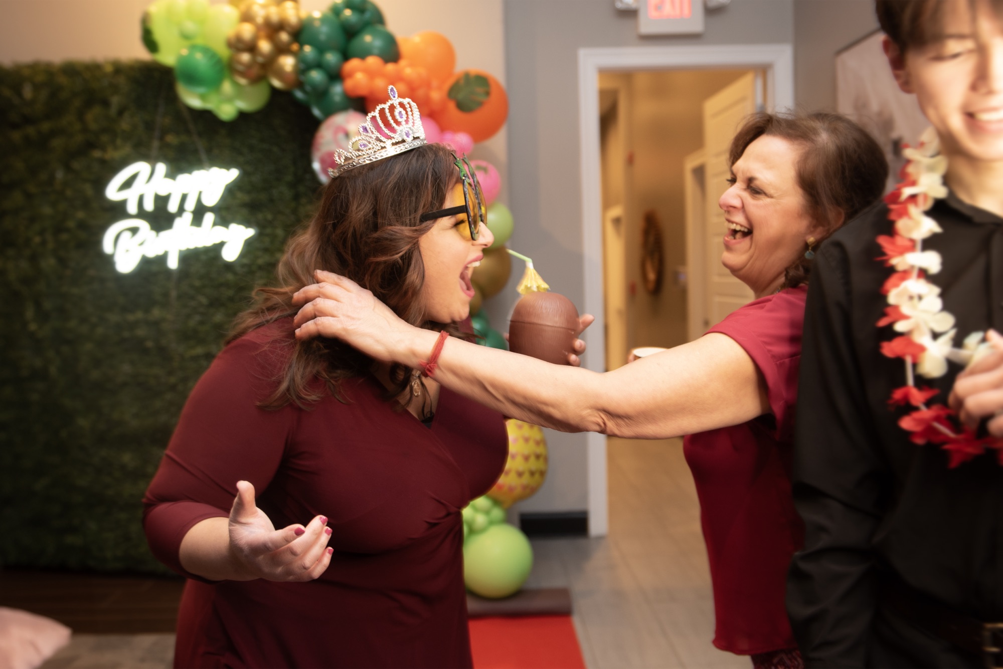 Guests laughing in front of the NextSpin booth at a birthday party.
